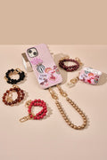 Funda personalizada para iPhone con straps y accesorios en una combinación elegante y colorida.