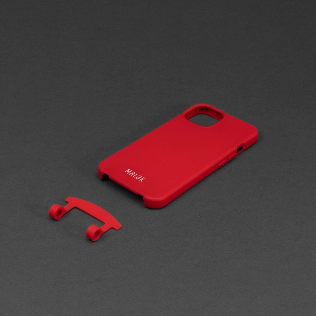 Funda de teléfono 2 en 1 con cordón en color rojo, destacando la pieza separada y el logo de Malak.